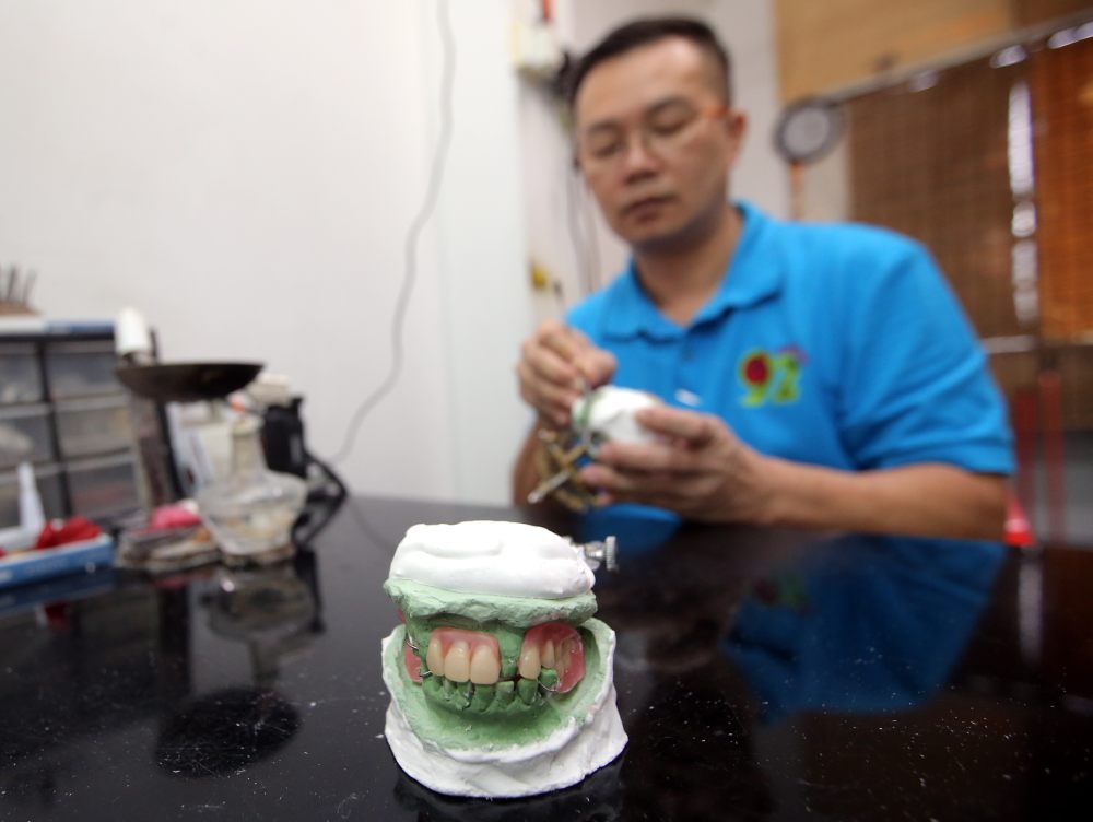 Good old-fashioned manual work and artistry of your dental technologist such as Loh, crafts that winning smile.