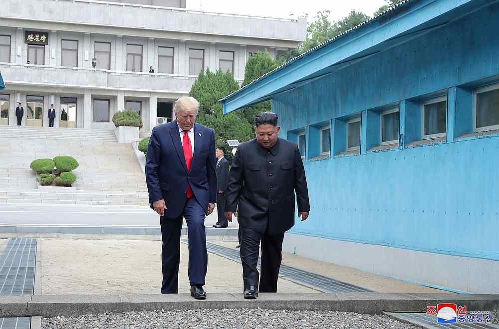 US President Donald Trump and North Korean leader Kim Jong-un cross over a military demarcation line at the demilitarised zone (DMZ) in Panmunjom, South Korea June 30, 2019. u00e2u20acu201d KCNA pic via Reuters
