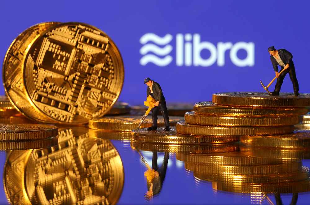 Small toy figures are seen on representations of virtual currency in front of the Libra logo in this illustration picture June 21, 2019. u00e2u20acu201d Reuters pic