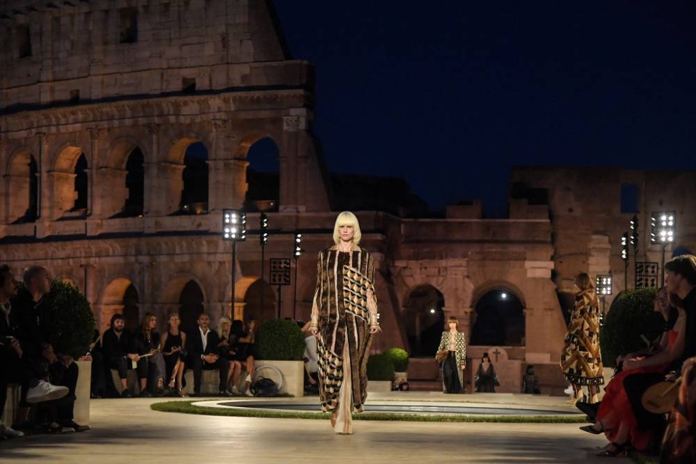 A model presents a creation during the outdoors presentation of Fendi's Couture Fall/Winter 2019-2020 show on July 4, 2019 at the Palatine Hill in Rome, with the Colosseo (Colosseum) monument in background. u00e2u20acu2022 AFP pic