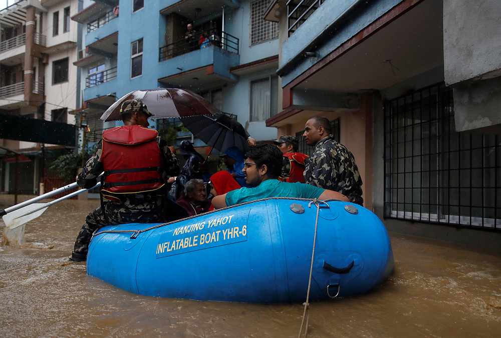 Residents are carried out on a boat in a flooded colony in Kathmandu, Nepal July 12, 2019. u00e2u20acu201d Reuters pic