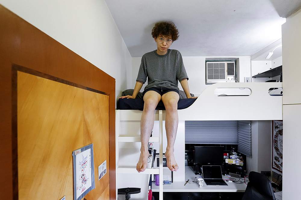 Native Hong Kong resident Fung Cheng, 25, a graphic designer, poses for a picture in his five square metre bedroom of his family's apartment in Hong Kong June 27, 2019. u00e2u20acu201d Reuters pic