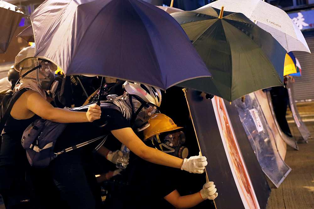 Demonstrators use umbrellas and makeshift shields to cover, as they face riot police during a protest against police violence in Hong Kong July 28, 2019. u00e2u20acu201d Reuters pic
