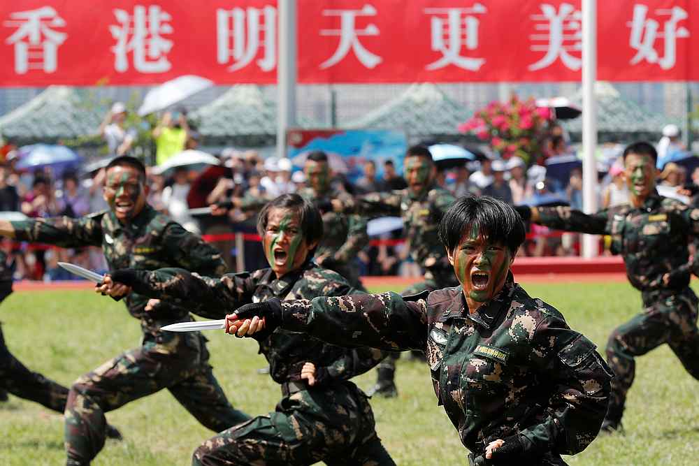 The People's Liberation Army Special Operations Forces perform in front of a banner 'Hong Kong a Better Tomorrow' at the Stonecutters Island naval base, in Hong Kong June 30, 2019. u00e2u20acu201d Reuters pic