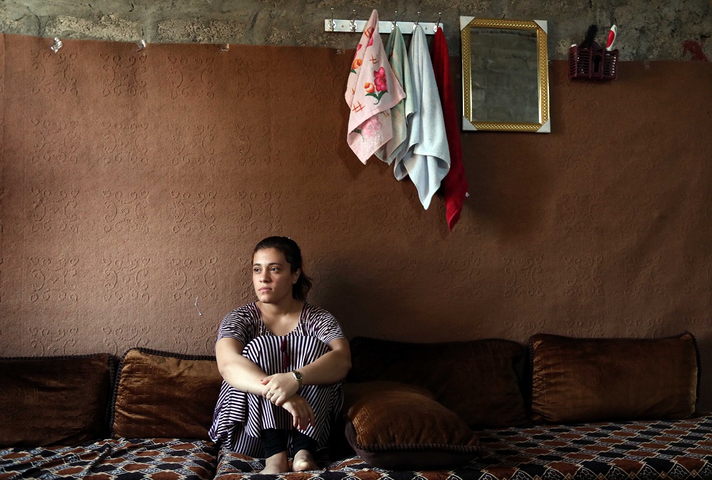 Iraq's Yazidi Jihan Qassem, 18, pauses as she talks to a AFP reporter at a makeshift house in an area housing many displaced people on the outskirts of the northwestern Iraqi town of Baadre June 25, 2019. u00e2u20acu201d AFP pic      