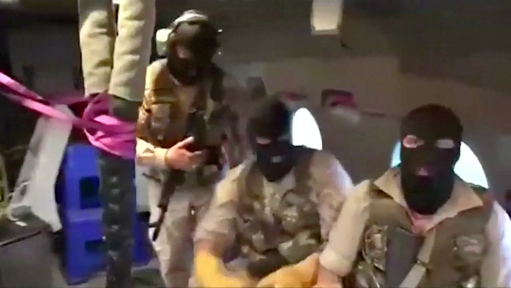 Iranian Revolutionary Guard troops wearing ski masksare seen on board a helicopter flying over British-flagged tanker Stena Impero near the strait of Hormuz July 19, 2019. Pool image via Wana/Reuters TV image