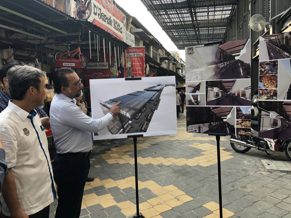 Jagdeep and Yew (left) showing the artistu00e2u20acu2122s impression of the canopy at Walk@Chowrasta July 24, 2019.  u00e2u20acu201d Picture By Opalyn Mok