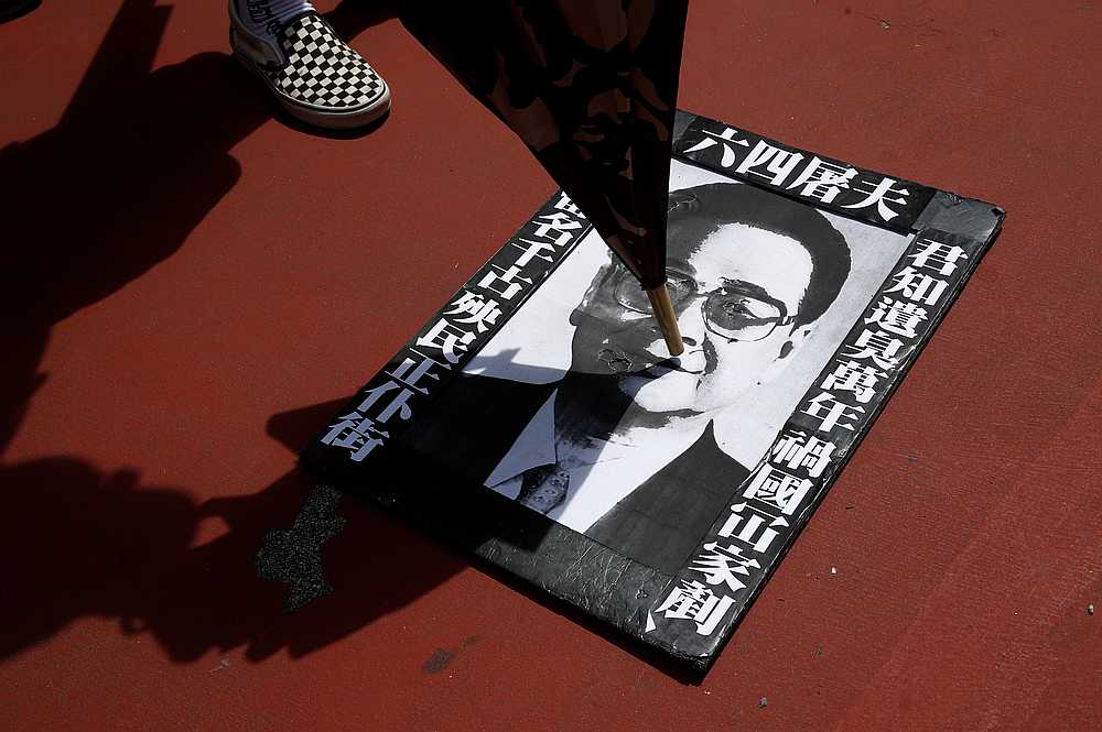 People step and spit at a portrait of former premier of China Li Peng during a protest against the Yuen Long attacks in Hong Kong July 27, 2019. u00e2u20acu201d Reuters pic