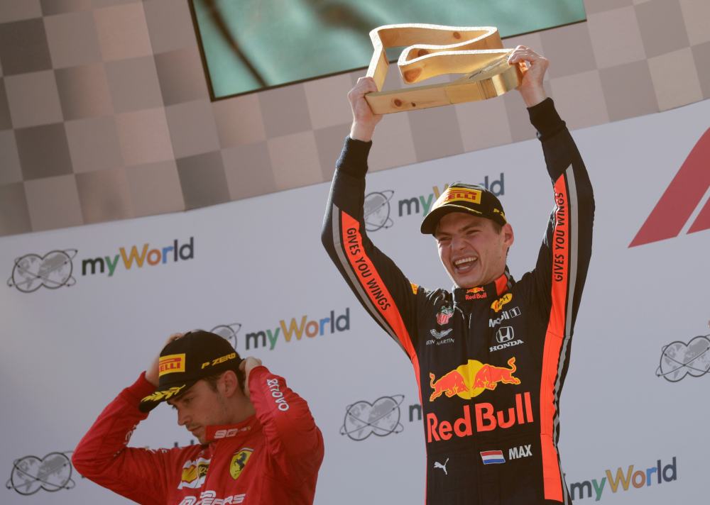 Red Bull's Max Verstappen celebrates after winning the Austrian Grand Prix as second placed Ferrari's Charles Leclerc looks dejected on the podium, June 30, 2019. u00e2u20acu2022 Reuters pic