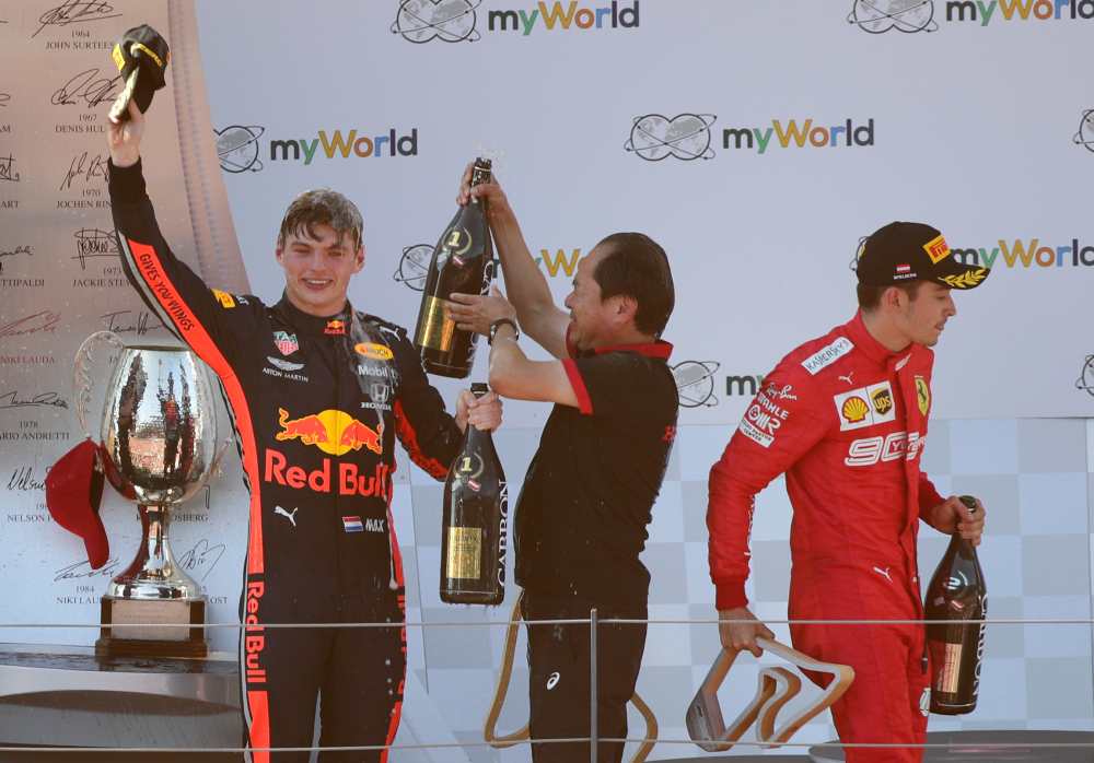 Red Bull's Max Verstappen celebrates after winning the Austrian Grand Prix as second placed Ferrari's Charles Leclerc looks dejected on the podium, June 30, 2019. u00e2u20acu2022 Reuters pic