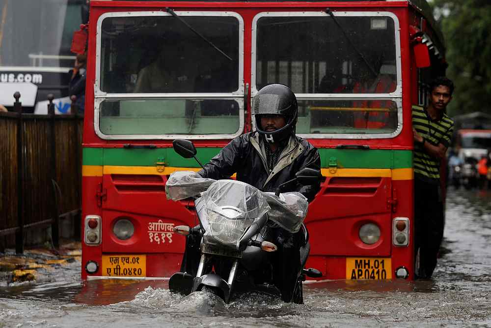 A man rides a motorcycle through a water-logged street during heavy rains in Mumbai, India July 1, 2019.  u00e2u20acu201d Reuters pic