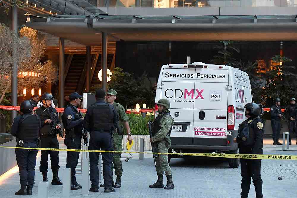 Soldiers and police officers keep watch near a forensic vehicle following a shooting at Plaza Artz Pedregal shopping mall in Mexico City July 24, 2019. u00e2u20acu201d Reuters pic