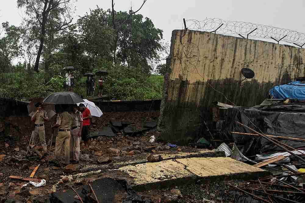 Police stand among the debris after a wall collapsed on hutments due to heavy rains in Mumbai, India July 2, 2019. u00e2u20acu201d Reuters pic