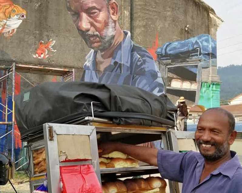 Muniandi with a mural of him done by street artist Andhar A. Samah. u00e2u20acu201d Picture via Facebook/Andhar A. Samah