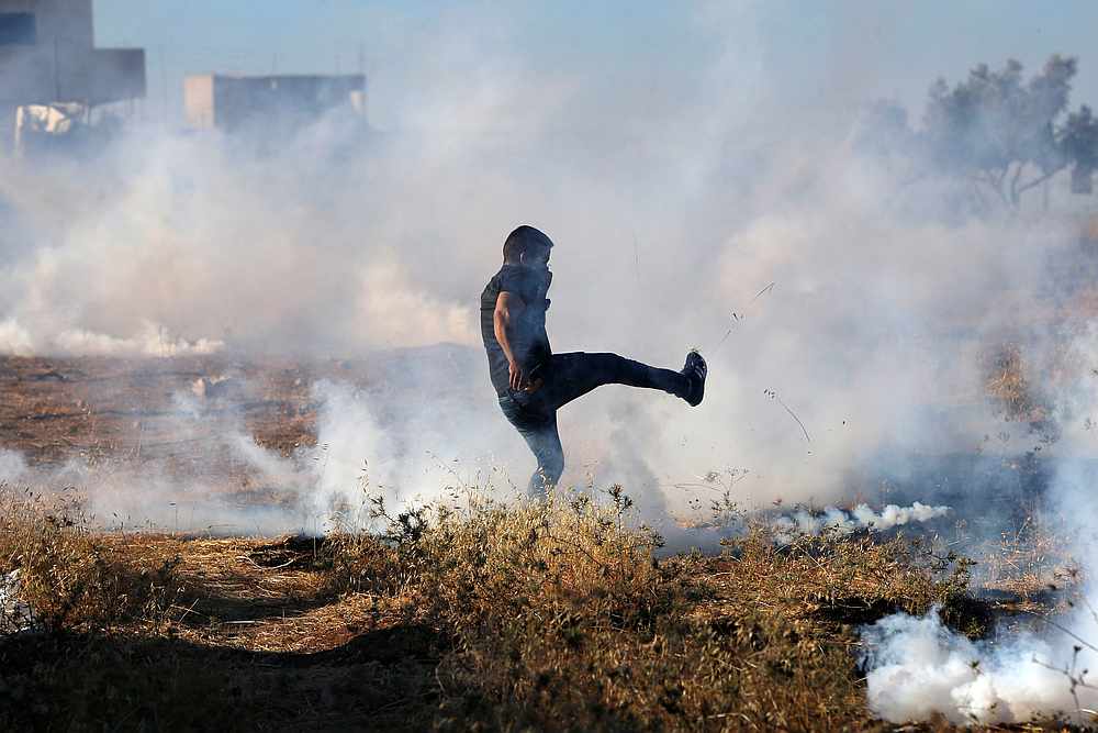A Palestinian demonstrator kicks a tear gas canister fired by Israeli forces in the Palestinian village of Sur Baher which sits on either side of the barrier in East Jerusalem and the Israeli-occupied West Bank July 20, 2019. u00e2u20acu201d Reuters pic