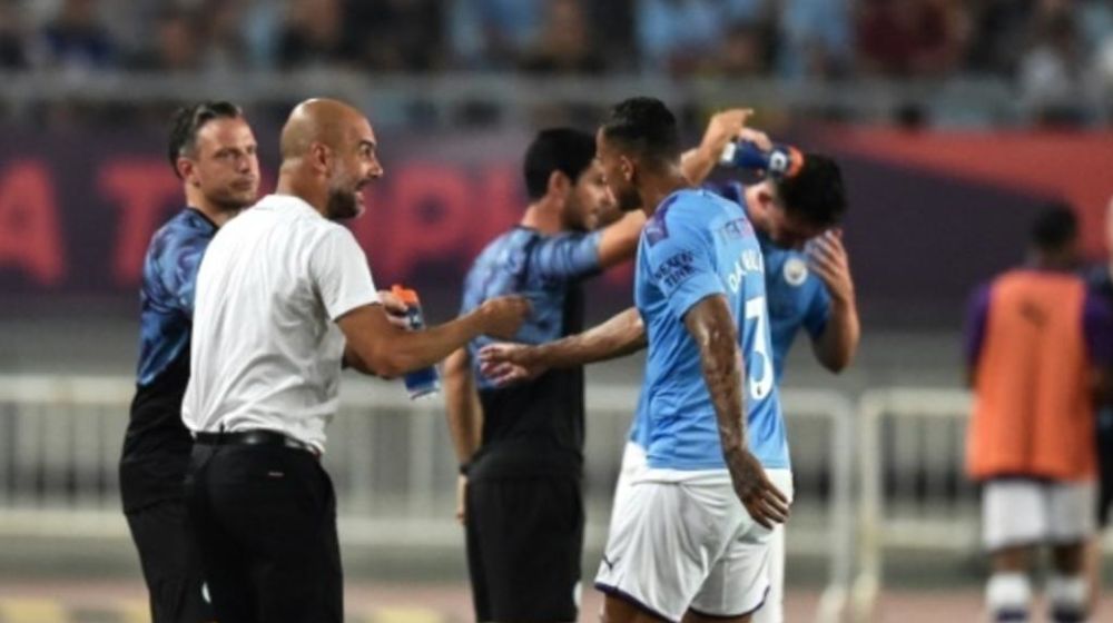 Pep Guardiola gives instructions to his Manchester City players on the sideline in Nanjing. u00e2u20acu201d AFP pic