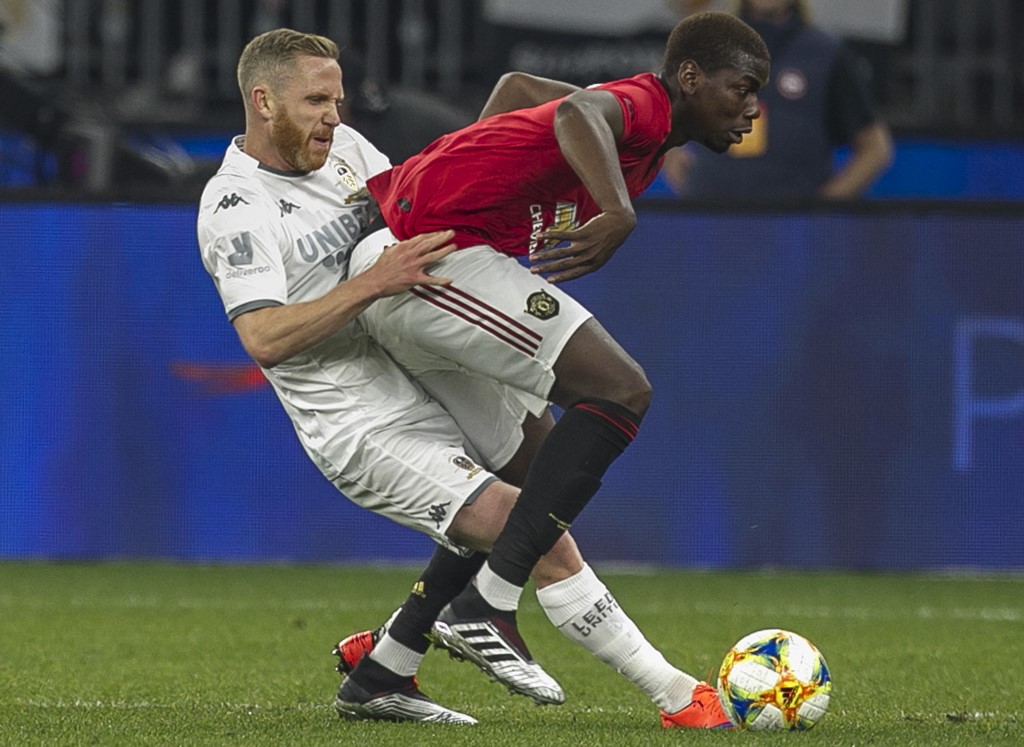 Manchester Unitedu00e2u20acu2122s Paul Pogba (right) fights for the ball with Leeds Unitedu00e2u20acu2122s Adam Forshaw during their pre-season friendly match at Optus Stadium in Perth on July 17, 2019. u00e2u20acu201d AFP pic