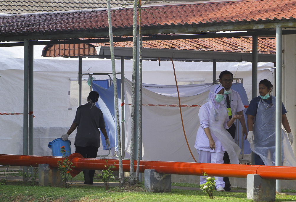 Hospital Port Dickson (HPD) staff members are seen leaving the isolation room where Sekolah Kebangsaan (SK) Linggi students who inhaled pesticide are being treated in Port Dickson July 18, 2019. u00e2u20acu201d Bernama pic