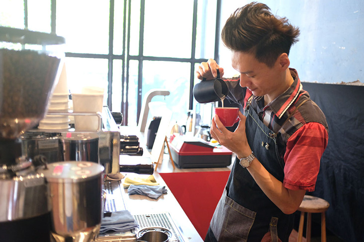 Barista pouring latte art at PPP Coffee’s REXKL pop-up.