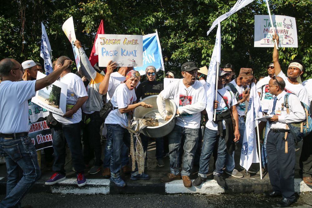 Fishermen from Penang and Perak gather outside the Parliament building to protest against the Penang South Reclamation project in Kuala Lumpur July 11, 2019. — Picture by Yusof Mat Isa