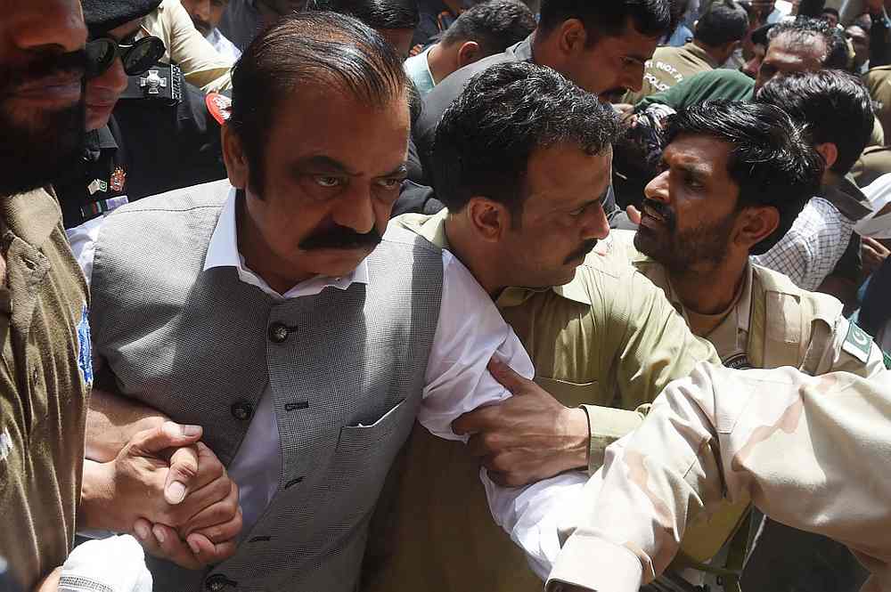 Security officials of the Anti-Narcotics Force (ANF) escort arrested senior leader of Pakistan Muslim League-Nawaz (PML-N) Rana Sanaullah (left) to court in Lahore on July 2, 2019. u00e2u20acu201d AFP pic