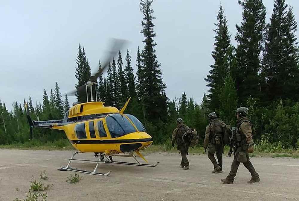 Royal Canadian Mounted Police (RCMP) officers conduct search for two fugitive teenagers wanted in the killing of three people, near Gillam in northern Manitoba July 26, 2019. u00e2u20acu201d RCMP Manitoba handout via Reuters