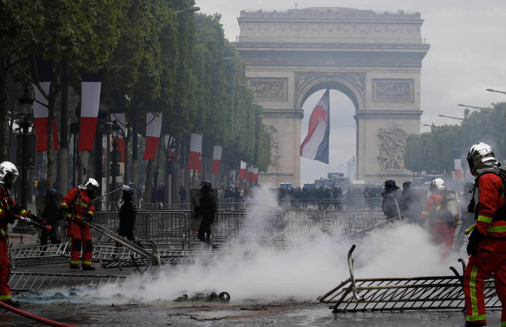 French firefighters extinguish a fire on the Champs Elysees avenue near the Arc de Triomphe during clashes with protesters after the traditional Bastille Day military parade in Paris July 14, 2019. u00e2u20acu201d Reuters pic
