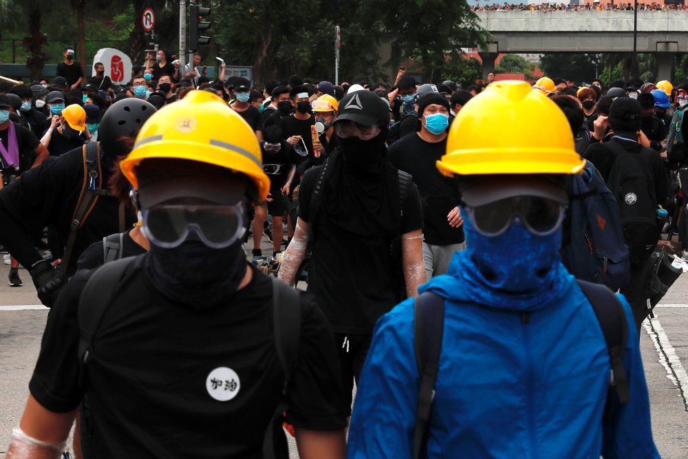 Anti-extradition bill protesters set up barriers as they face riot police after a march at Sha Tin District of East New Territories, Hong Kong July 14, 2019. u00e2u20acu201d Reuters pic