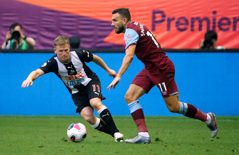 West Hamu00e2u20acu2122s Robert Snodgrass in action with Newcastle Unitedu00e2u20acu2122s Matt Ritchie during the Premier League Asia Trophy match at Hongkou Football Stadium, Shanghai July 20, 2019. u00e2u20acu201d Reuters pic