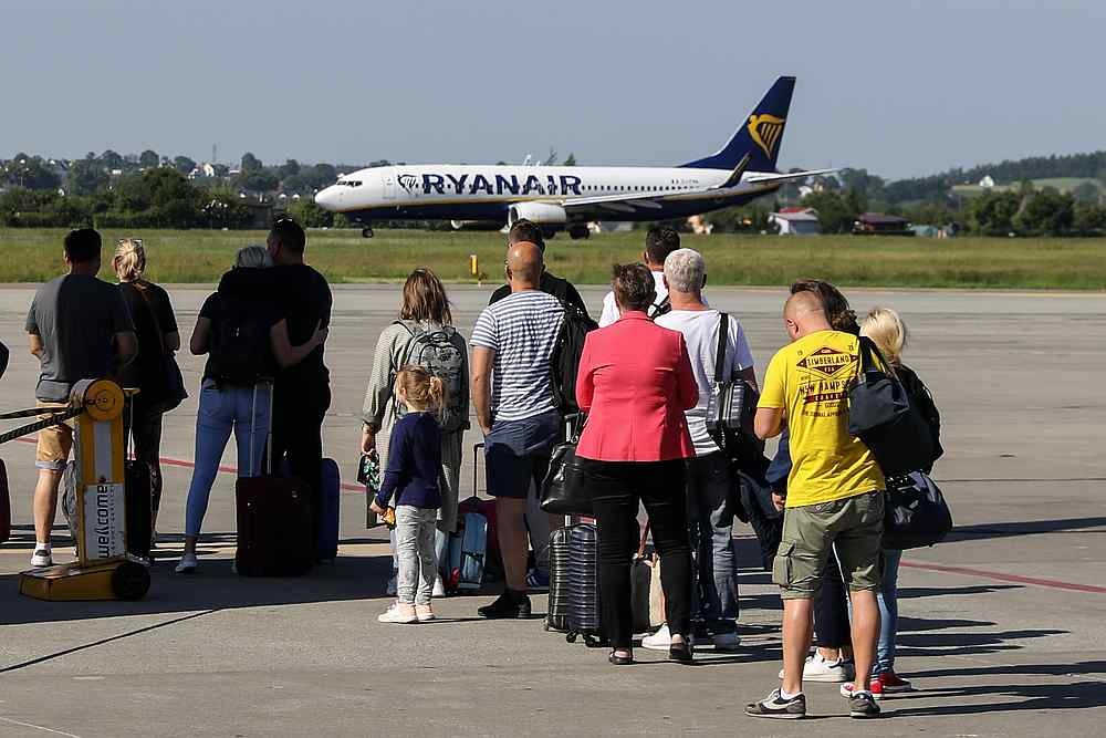 Passengers watch a Ryanair flight on the runway at the airport in Gdansk, Poland June 19, 2019. u00e2u20acu201d Reuters pic