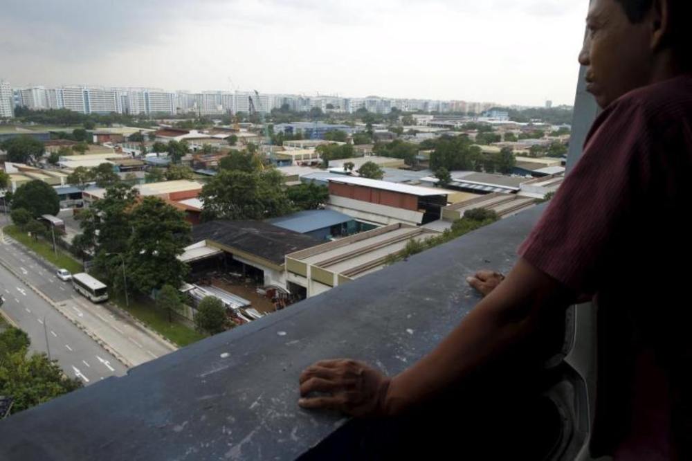 A man looking at a cluster of factories at an industrial park in Singapore. u00e2u20acu2022 TODAY picnn