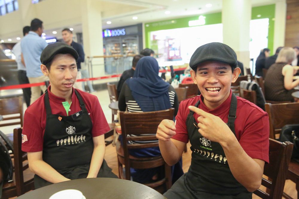 Akmal conveying his replies through sign language, with the help of an interpreter.