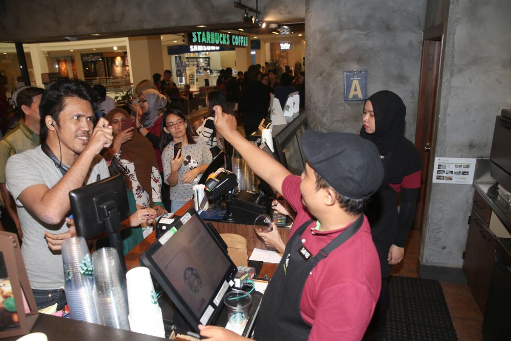 Media attendees ordering their favourite beverage in sign language.