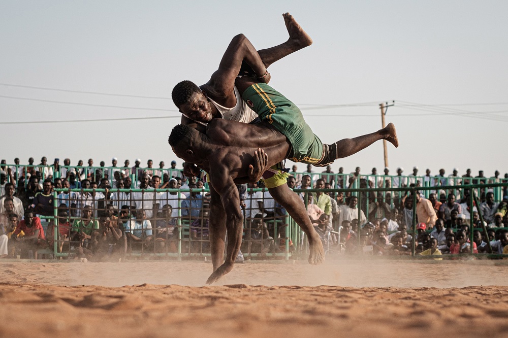 Sudanese wrestlers fight during a traditional Nuba wrestling match at the Haj Youssef stadium in the district of Khartoum. u00e2u20acu201d AFP pic          