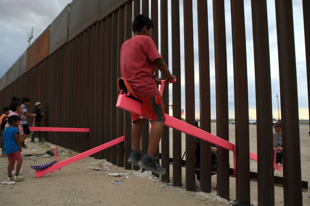 American and Mexican families play with a toy called u00e2u20acu02dcup and downu00e2u20acu2122 (Seesaw swing) over the Mexican border with US at the Anapra zone in Ciudad Juarez, Chihuahua State, Mexico on July 28, 2019. u00e2u20acu201d AFP pic