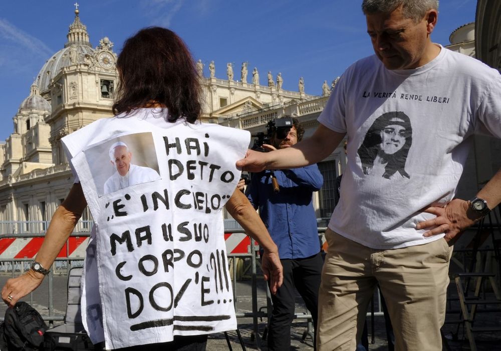 A woman wears a jersey with a photo of the Pope, and reading u00e2u20acu02dcHe said she was in heaven, but where is her body ?u00e2u20acu2122 referring to Emanuela Orlandi, a teenager who disappeared in 1983, as people gather by the Vatican on July 11, 2019. u00e2u20acu201d AFP pic