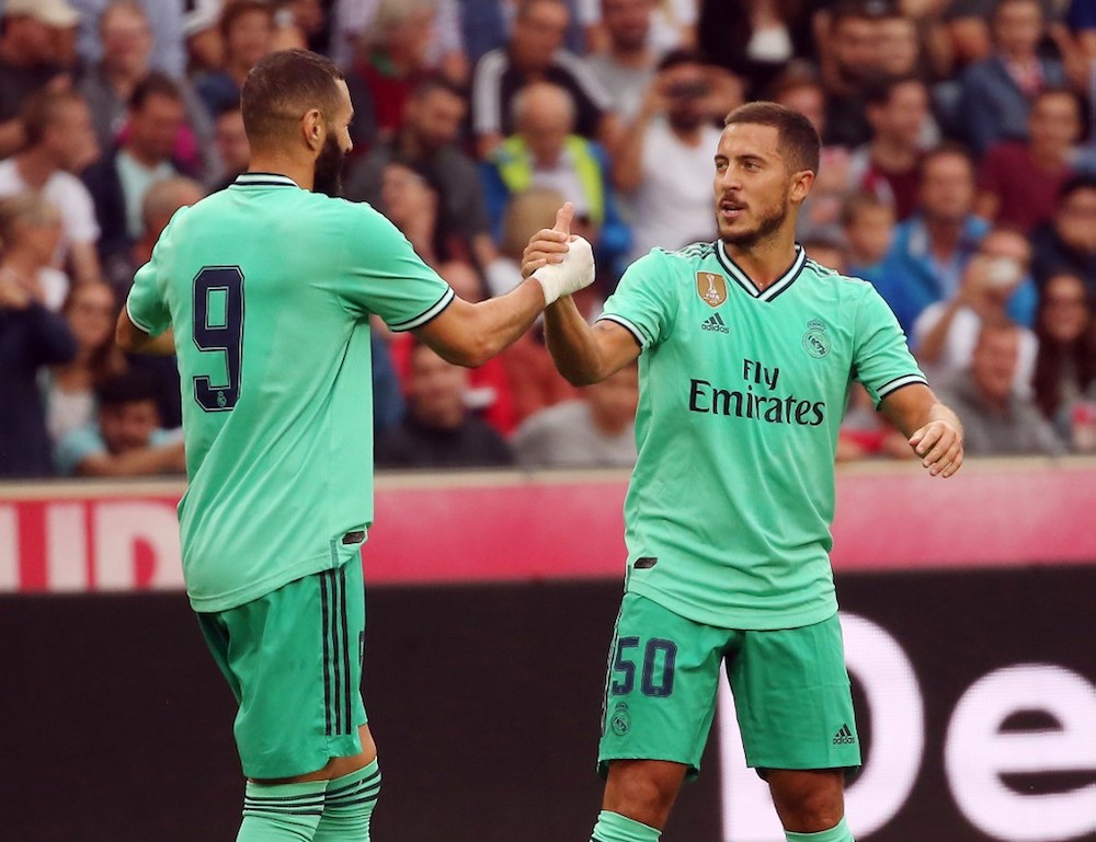 Real Madridu00e2u20acu2122s Eden Hazard celebrates scoring with his team-mate Karim Benzema during the pre-season friendly with FC Red Bull Salzburg in Salzburg, Austria August 7, 2019. u00e2u20acu201d AFP pic
