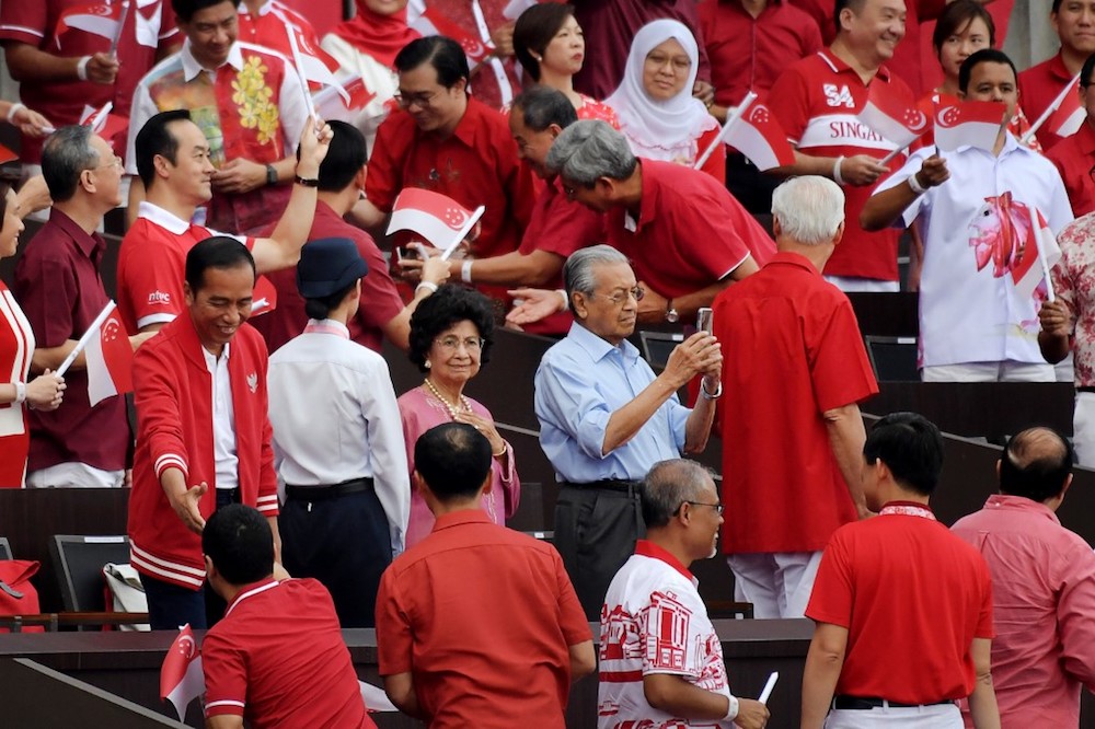 Indonesiau00e2u20acu2122s President Joko Widodo, Malaysiau00e2u20acu2122s Prime Minister Tun Dr Mahathir Mohamad and his wife Tun Dr Siti Hasmah Mohamad Ali attend the 54th National Day Parade in Singapore August 9, 2019. u00e2u20acu201d AFP pic
