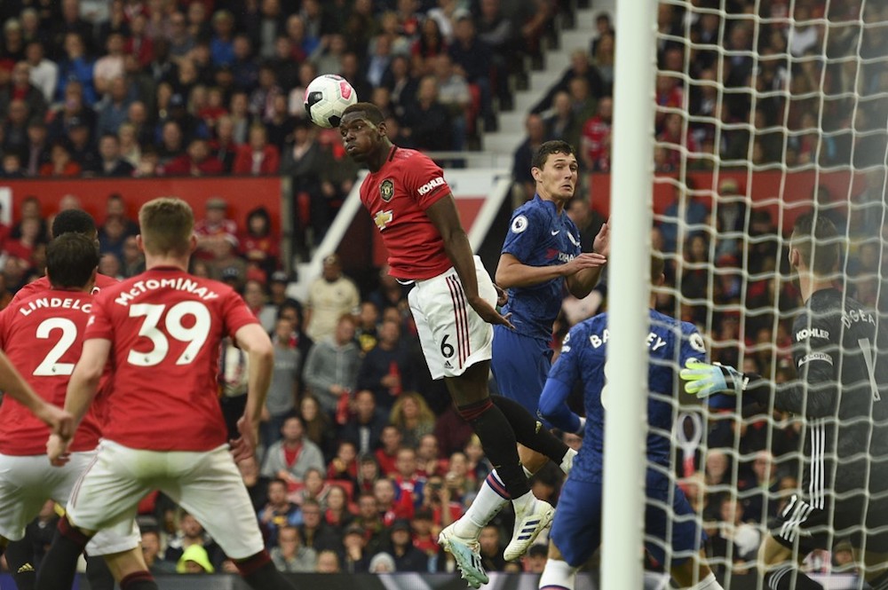 Manchester United’s Paul Pogba wins a defensive header during the English Premier League match with Chelsea at Old Trafford in Manchester August 11, 2019. — AFP pic