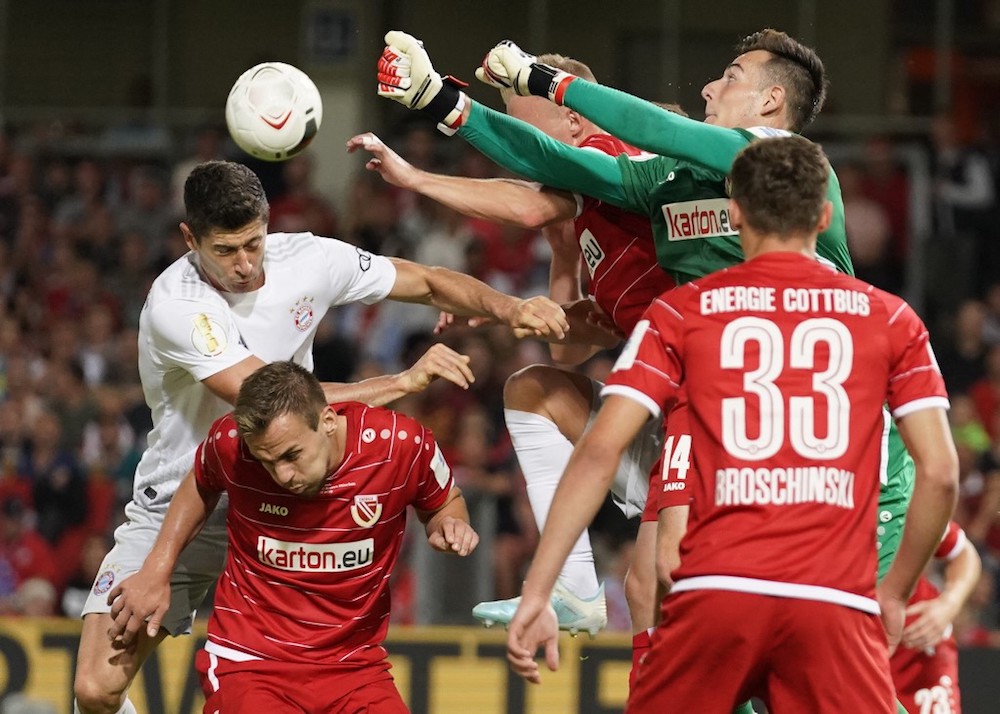 Bayern Munichu00e2u20acu2122s Robert Lewandowski and Cottbusu00e2u20acu2122 goalkeeper Lennart Moser vie for the ball during their German Cup first round match at the Freundschaft stadium in Cottbus August 12, 2019. u00e2u20acu201d AFP pic