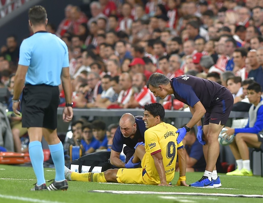 Doctors attend Barcelonau00e2u20acu2122s Luis Suarez during the La Liga match with Athletic Bilbao at the San Mames stadium in Bilbao August 16, 2019. u00e2u20acu201d AFP pic