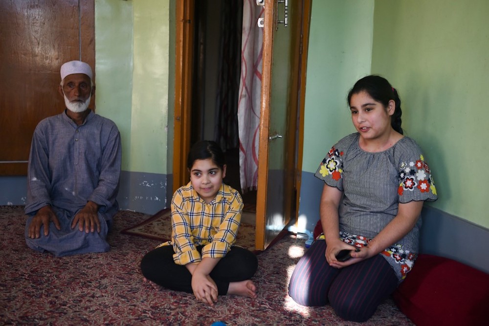 Thirteen-year-old Habila (right) speaks with AFP during an interview in her home in Srinagar August 19, 2019, where her father Showkat Shafi says she must stay instead of going to school until tensions in the region subside. — AFP pic