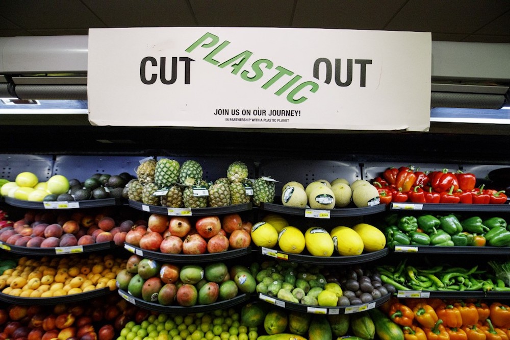 A sign promoting plastic free packaging is seen above a display of loose fresh fruit at Budgens supermarket in Belsize Park, north London July 2, 2019. — AFP pic