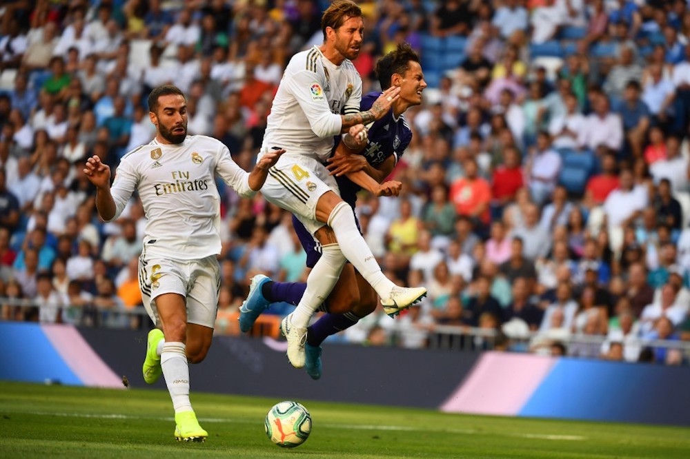 Real Madridu00e2u20acu2122s Dani Carvajal and Sergio Ramos challenge Valladolidu00e2u20acu2122s Enes Unal during their La Liga match at the Santiago Bernabeu stadium in Madrid August 24, 2019. u00e2u20acu201d AFP pic