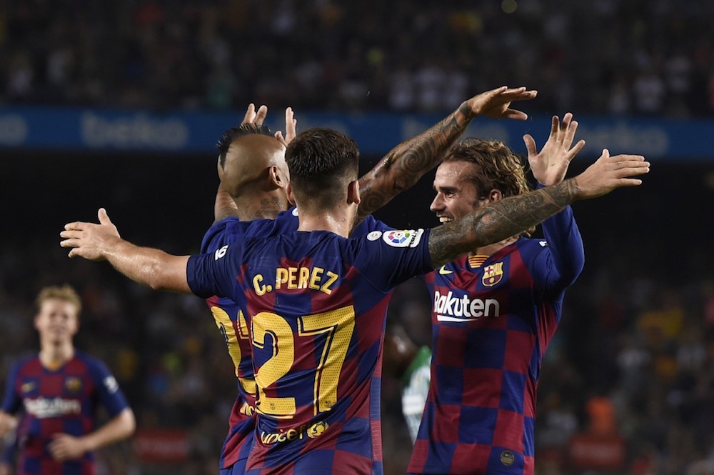 Barcelona’s Arturo Vidal celebrates with Carles Perez and Antoine Griezmann after scoring during the La Liga match with Real Betis at the Camp Nou stadium in Barcelona August 25, 2019. — AFP pic