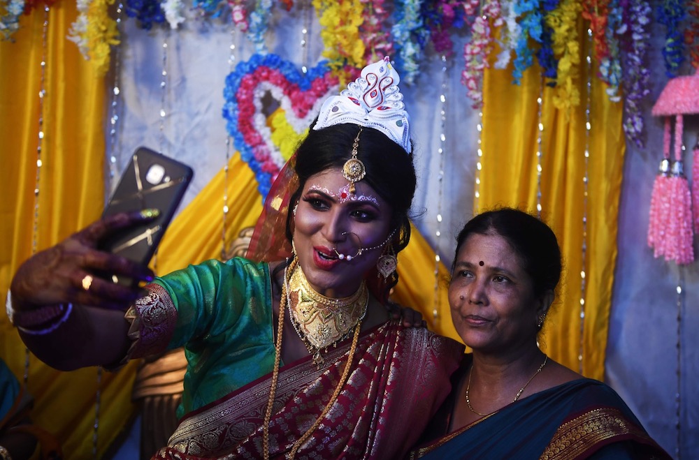 This photo taken on August 5, 2019 shows transgender woman Tista Das, smiling as she takes a selfie photo with her mother Subhra Das at her wedding to a transgender man in Kolkata. u00e2u20acu201d AFP pic