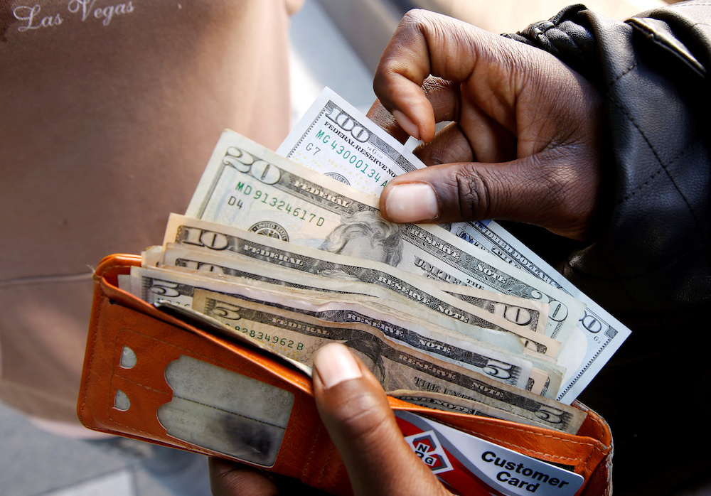 A man displays US dollar notes after withdrawing cash from a bank in Harare, Zimbabwe, July 9, 2019. u00e2u20acu201d Reuters pic