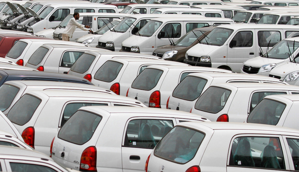 A worker adjusts the windscreen wipers of a parked car at a Maruti Suzuki stockyard on the outskirts of the western Indian city of Ahmedabad September 1, 2011. u00e2u20acu201d Reuters pic