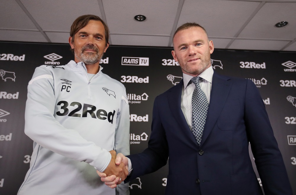 Derby County manager Phillip Cocu and Wayne Rooney pose during a press conference at Pride Park in Derby August 6, 2019. u00e2u20acu201d Action Images via Reuters
