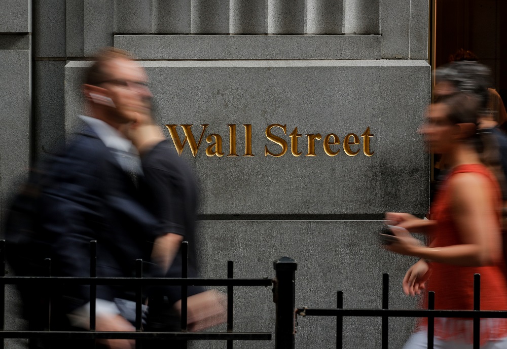 People walk on Wall St. outside the New York Stock Exchange (NYSE) in New York August 7, 2019. u00e2u20acu201d Reuters pic